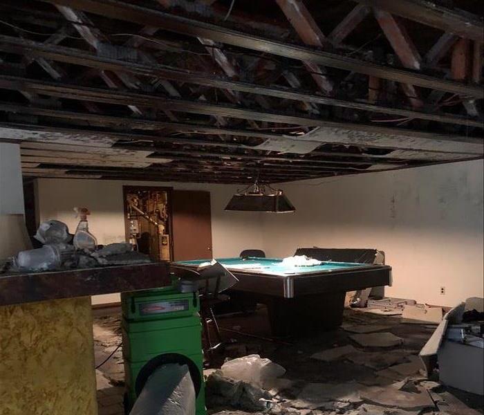  Fire damage game room, burnt trusses and beams, pool table in middle