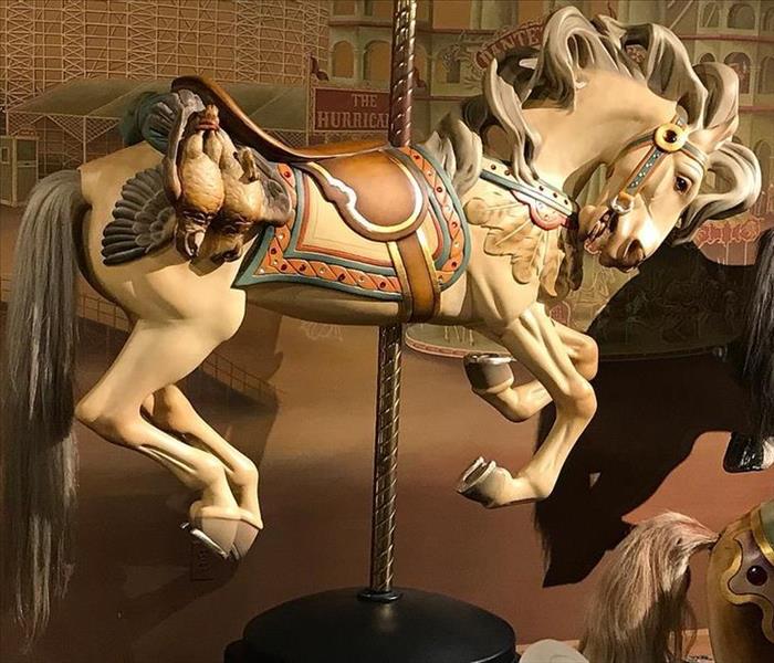 Cream Carousel horse with grey tail hair and brown saddle