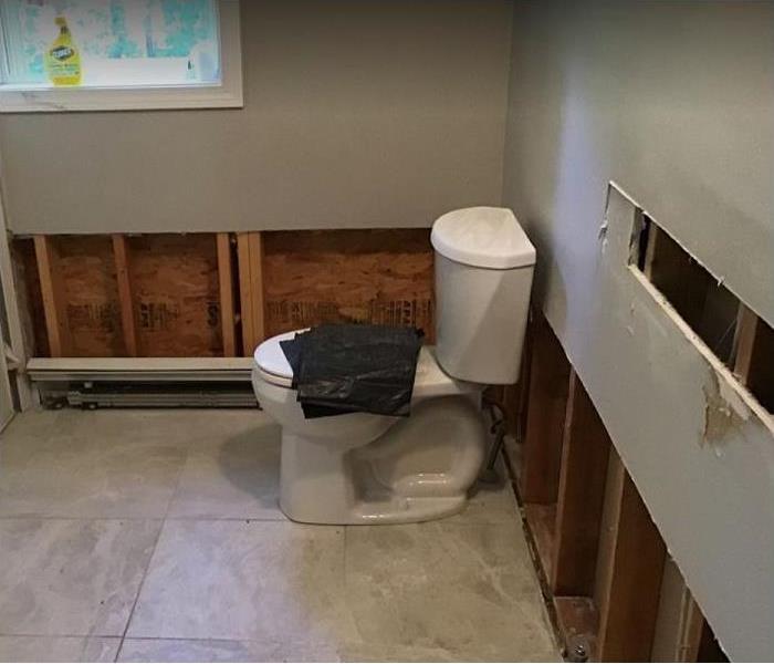 water damaged bathroom; flood cuts in walls